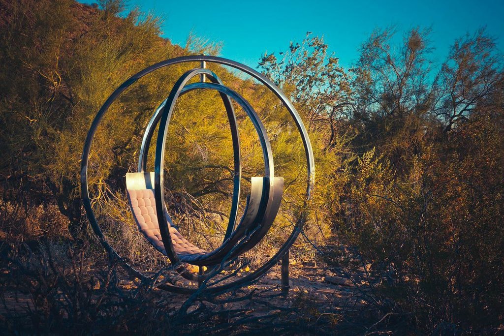 Etazin sculptural chair against a sunset landscape